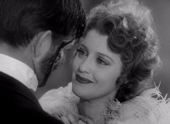 Movie still from “San Francisco” (1936), directed by W.S. Van Dyke – A man and a woman smiling for the camera; Close Up shot, Over the shoulder angle