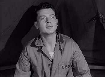 Movie still from “Sands of Iwo Jima” (1949), directed by Allan Dwan – A black and white photo of a man in a military uniform; Close Up shot, Low angle