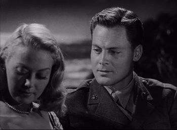 Movie still from “Sands of Iwo Jima” (1949), directed by Allan Dwan – A man and a woman are looking at each other; Close Up shot, Low angle