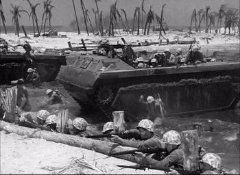 Movie still from “Sands of Iwo Jima” (1949), directed by Allan Dwan – A black and white photo of soldiers on a beach; Wide shot, Low angle
