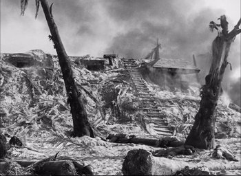 Movie still from “Sands of Iwo Jima” (1949), directed by Allan Dwan – A black - and - white photo of a destroyed building; Extreme Wide shot, High angle