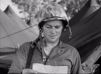 Movie still from “Sands of Iwo Jima” (1949), directed by Allan Dwan – A man wearing a helmet is reading a piece of paper; Close Up shot, High angle