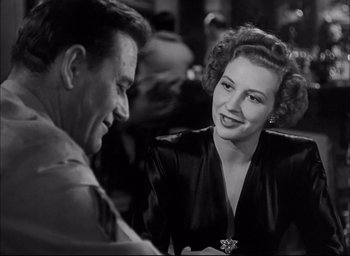 Movie still from “Sands of Iwo Jima” (1949), directed by Allan Dwan – An old photo of a man and a woman talking to each other; Close Up shot, Over the shoulder angle