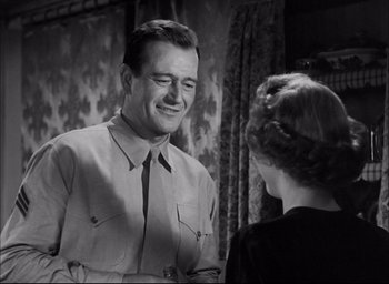 Movie still from “Sands of Iwo Jima” (1949), directed by Allan Dwan – A man and a woman talking to each other; Medium shot, Over the shoulder angle