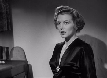 Movie still from “Sands of Iwo Jima” (1949), directed by Allan Dwan – An old photo of a woman in a black dress; Close Up shot, Low angle