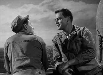 Movie still from “Sands of Iwo Jima” (1949), directed by Allan Dwan – Two men talking to each other while sitting in a car; Medium shot, High angle