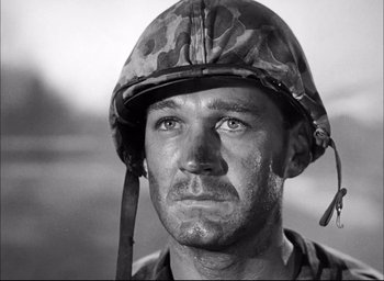 Movie still from “Sands of Iwo Jima” (1949), directed by Allan Dwan – Black and white photograph of a man wearing a helmet; Close Up shot, Low angle