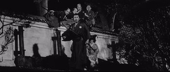 Movie still from “Sanjuro” (1962), directed by Akira Kurosawa – A group of people dressed in traditional japanese garb; Wide shot, Low angle