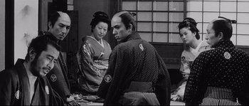 Movie still from “Sanjuro” (1962), directed by Akira Kurosawa – A man and a woman dressed in traditional japanese garb; Medium shot, Over the shoulder angle