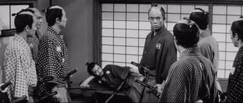 Movie still from “Sanjuro” (1962), directed by Akira Kurosawa – A man and a woman are posing for a picture; Medium shot, Over the shoulder angle
