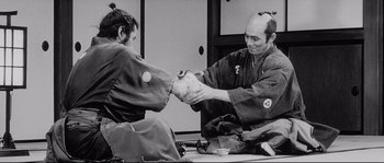 Movie still from “Sanjuro” (1962), directed by Akira Kurosawa – A man and a woman in traditional japanese garb; Medium shot, Over the shoulder angle