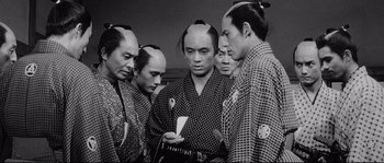 Movie still from “Sanjuro” (1962), directed by Akira Kurosawa – A group of asian men standing next to each other; Medium shot, High angle