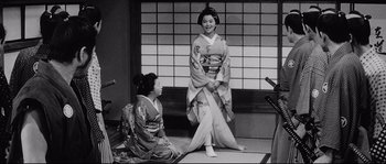 Movie still from “Sanjuro” (1962), directed by Akira Kurosawa – Two women dressed in traditional geisha outfits; Wide shot, Over the shoulder angle