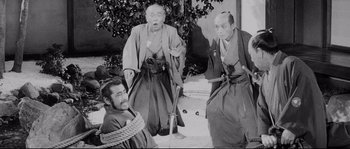 Movie still from “Sanjuro” (1962), directed by Akira Kurosawa – A group of men in traditional japanese garb; Wide shot, High angle