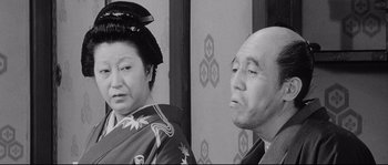 Movie still from “Sanjuro” (1962), directed by Akira Kurosawa – An older man and a younger woman in traditional garb; Medium shot, Over the shoulder angle