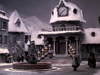 Movie still from “Santa Claus Is Comin' to Town” (1970), directed by Jules Bass – A large building with a clock on the top of it; Extreme Wide shot, High angle