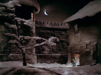 Movie still from “Santa Claus Is Comin' to Town” (1970), directed by Jules Bass – A man standing in a doorway of an old building; Extreme Wide shot, High angle
