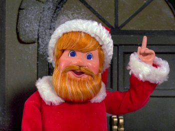 Movie still from “Santa Claus Is Comin' to Town” (1970), directed by Jules Bass – The head of a santa clause doll; Close Up shot, Low angle