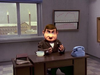 Movie still from “Santa Claus Is Comin' to Town” (1970), directed by Jules Bass – A man sitting at a desk in front of a phone; Medium shot, High angle