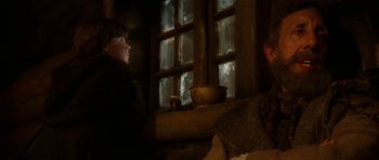 Movie still from “Santa Claus” (1985), directed by Jeannot Szwarc – A man and a woman sitting in front of a window; Close Up shot, Over the shoulder angle