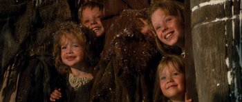 Movie still from “Santa Claus” (1985), directed by Jeannot Szwarc – A group of children smiling for the camera; Close Up shot, Low angle