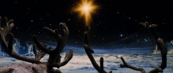 Movie still from “Santa Claus” (1985), directed by Jeannot Szwarc – A view of the earth from a space station; Extreme Wide shot, Low angle