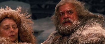 Movie still from “Santa Claus” (1985), directed by Jeannot Szwarc – A man with a beard and a long white beard; Close Up shot, Over the shoulder angle