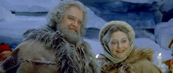Movie still from “Santa Claus” (1985), directed by Jeannot Szwarc – A man and a woman dressed in winter clothing; Close Up shot, Low angle