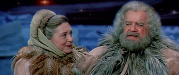 Movie still from “Santa Claus” (1985), directed by Jeannot Szwarc – A man and a woman dressed in furry clothing; Close Up shot, Over the shoulder angle