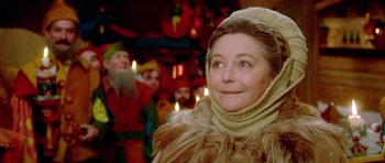 Movie still from “Santa Claus” (1985), directed by Jeannot Szwarc – A woman in a fur coat looking up at the sky; Close Up shot, Low angle