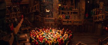 Movie still from “Santa Claus” (1985), directed by Jeannot Szwarc – A large group of clowns sitting in a circle; Extreme Wide shot, High angle