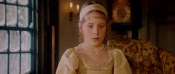 Movie still from “Santa Claus” (1985), directed by Jeannot Szwarc – A young girl wearing a white dress and a white head band; Close Up shot, Over the shoulder angle