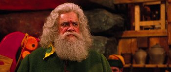 Movie still from “Santa Claus” (1985), directed by Jeannot Szwarc – An old man with a beard and long white beard; Close Up shot, Low angle