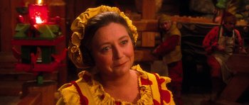 Movie still from “Santa Claus” (1985), directed by Jeannot Szwarc – A person wearing a costume; Close Up shot, Over the shoulder angle