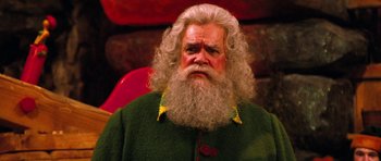 Movie still from “Santa Claus” (1985), directed by Jeannot Szwarc – An old man with long white hair and a long beard; Close Up shot, High angle