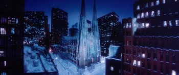 Movie still from “Santa Claus” (1985), directed by Jeannot Szwarc – A large church with a large building in the background; Extreme Wide shot, High angle