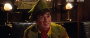 Movie still from “Santa Claus” (1985), directed by Jeannot Szwarc – A person wearing a costume; Close Up shot, High angle