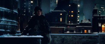 Movie still from “Santa Claus” (1985), directed by Jeannot Szwarc – A person sitting on a bench in the dark; Medium shot, High angle