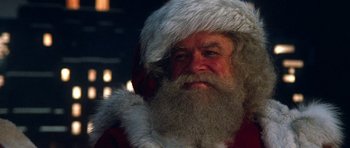 Movie still from “Santa Claus” (1985), directed by Jeannot Szwarc – A person wearing a santa claus costume; Close Up shot, Low angle