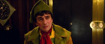 Movie still from “Santa Claus” (1985), directed by Jeannot Szwarc – A person wearing a costume; Close Up shot, Over the shoulder angle