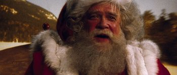 Movie still from “Santa Claus” (1985), directed by Jeannot Szwarc – An old man dressed as santa claus for christmas; Close Up shot, Low angle