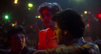 Movie still from “Saturday Night Fever” (1977), directed by John Badham – A woman and a man sitting in a room; Medium shot, Over the shoulder angle