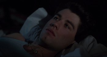 Movie still from “Saturday Night Fever” (1977), directed by John Badham – A person laying in a bed; Close Up shot, High angle