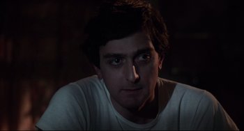 Movie still from “Saturday Night Fever” (1977), directed by John Badham – A person wearing a white t - shirt; Close Up shot, Low angle