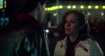 Movie still from “Saturday Night Fever” (1977), directed by John Badham – A man and a woman standing next to each other on a street; Close Up shot, Over the shoulder angle