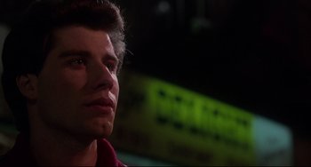 Movie still from “Saturday Night Fever” (1977), directed by John Badham – A person looking up at the sky; Close Up shot, Low angle