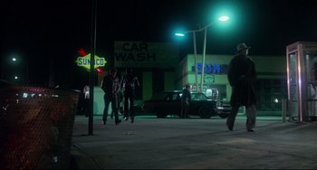 Movie still from “Saturday Night Fever” (1977), directed by John Badham – A group of people walking down a street at night; Extreme Wide shot, Low angle