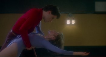 Movie still from “Saturday Night Fever” (1977), directed by John Badham – A man and a woman are performing a dance; Medium shot, Low angle