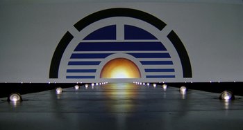 Movie still from “Saturn 3” (1980), directed by John Barry – The sun is setting in a room that has an art deco design on the wall; Extreme Wide shot, Low angle