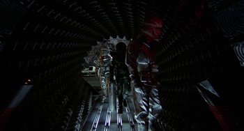 Movie still from “Saturn 3” (1980), directed by John Barry – A group of people walking down a ramp in a tunnel; Wide shot, Low angle